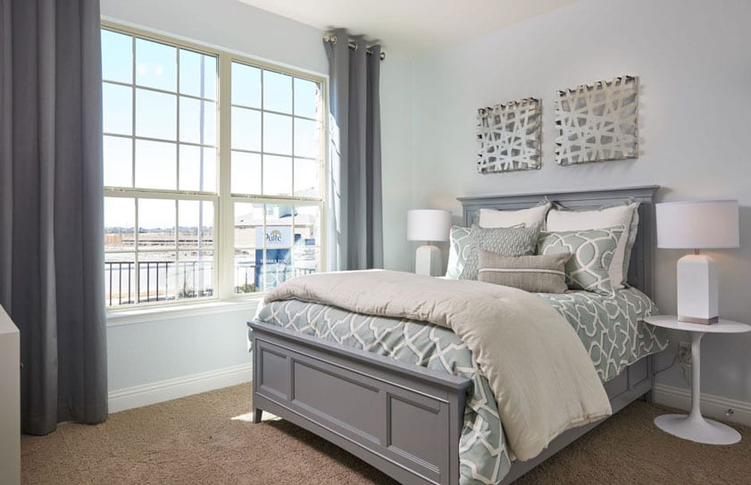 Gray and white bedroom with views of the Las Vegas strip seen out of the window