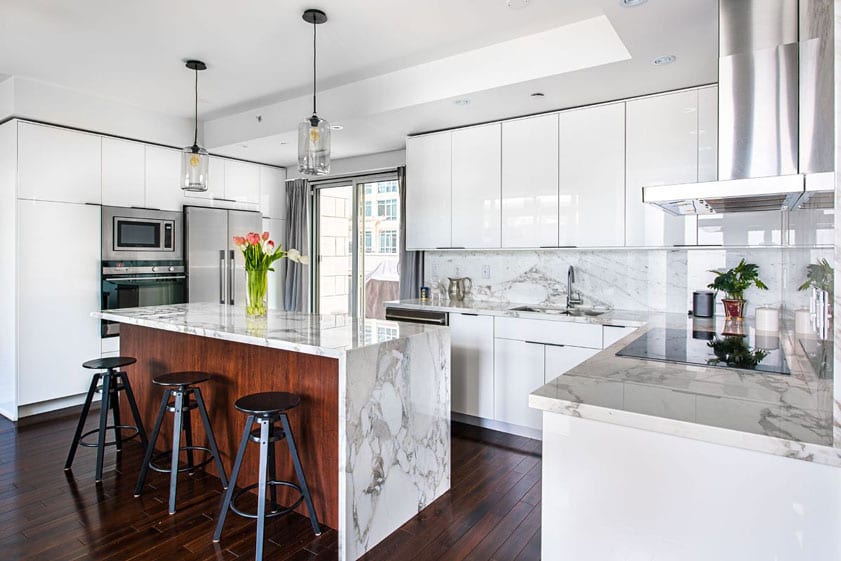 modern white kitchen with waterfall edge island in a Las Vegas home for sale