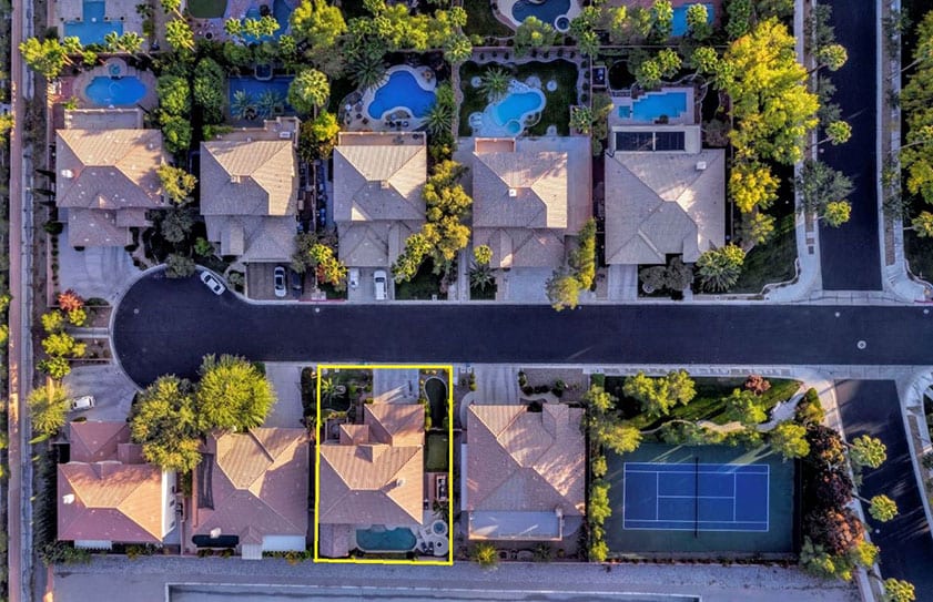 Drone photo of a property from directly above with yellow lines added to show property boundaries