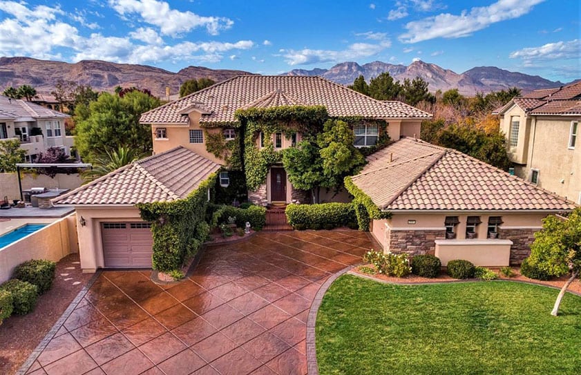 Large Las Vegas home seen from the air with views of the mountains in the background