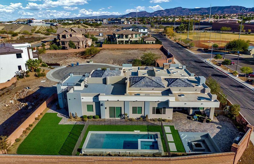 Drone photo of a large Las Vegas home with beautiful landscaping and pool.