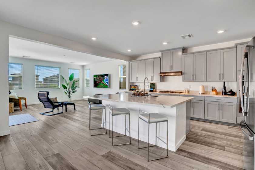 kitchen with three stools and hardwood floors