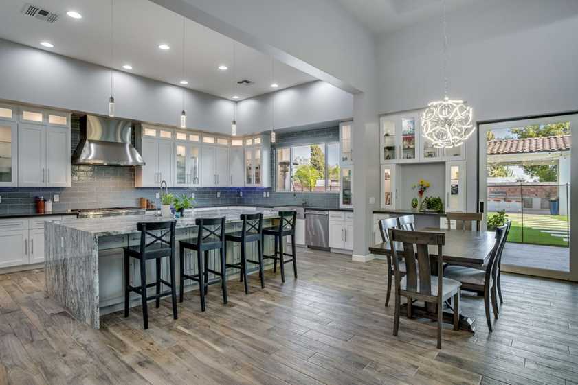 photograph of kitchen with hardwood floors and unique light fixtures