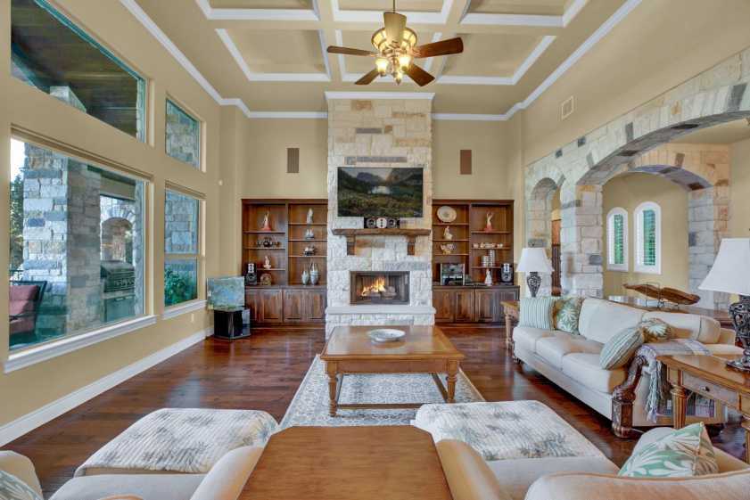 photo of living room with fireplace view of patio