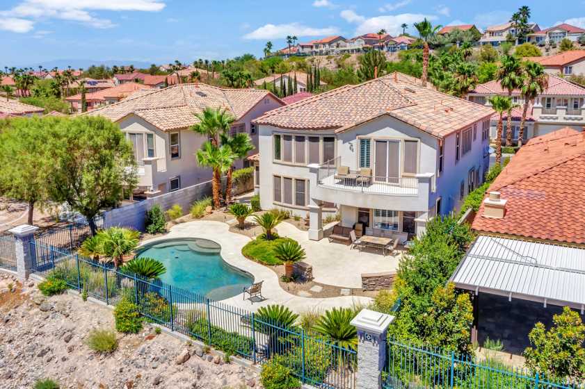 drone photograph of backyard with pool and view of mountain